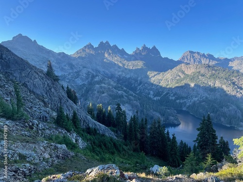 landscape in the mountains on the pacific crest trail looking over an alpine lake in a wooded valley