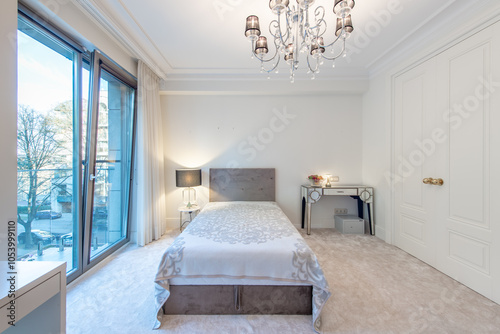 Closed White Wooden Door and Luxurious Master Home Bedroom Interior, Modern House, BeautifuI interior, King Size Bed. Window to Balcony, Table with Fruits. Luxury Lamp photo