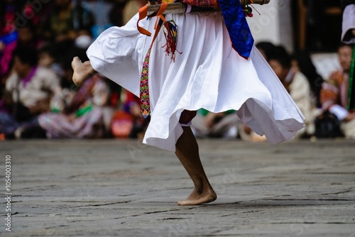 Traditional dancer's feet and attire in cultural performance. photo