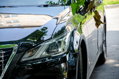 Part of a passenger car on the street in summer close-up