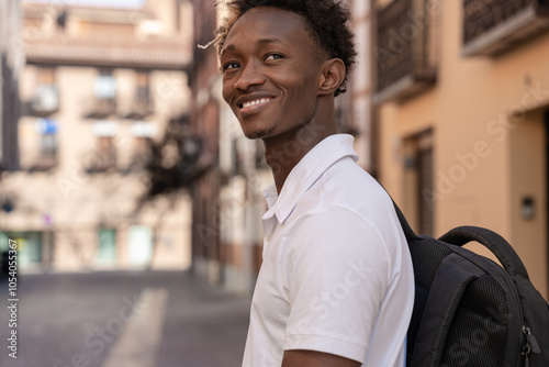 Young student smiling walking in the street photo