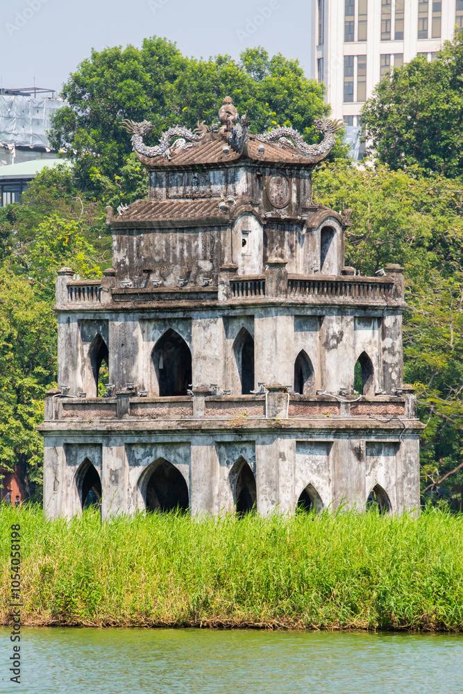 Obraz premium Hanoi, Vietnam, 11-06-2024: view of the Turtle Tower (Thap Rua), a small tower built in 1886 in the middle of Sword Lake (Hoan Kiem Lake), dedicated to the hero Le Loi, one of the symbol of the city