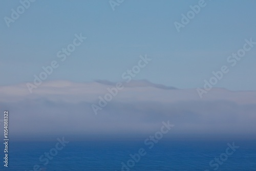 Varanger peninsula covered in sea mist in summer, Norway. photo