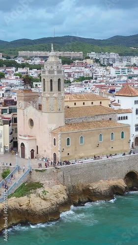 Sitges Catalonia Spain church San Bartolomé y Santa Tecla and sea aerial drone view from above. Vertical video footage