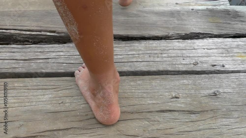 Follow Shot of a Woman's feet walking at Swamp Wood Bridge 1