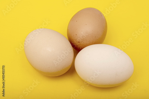 Chiken eggs on yellow background