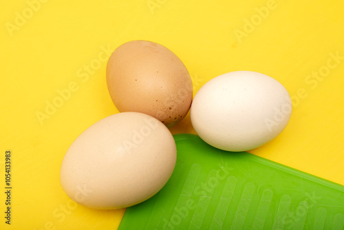 Chiken eggs on yellow background