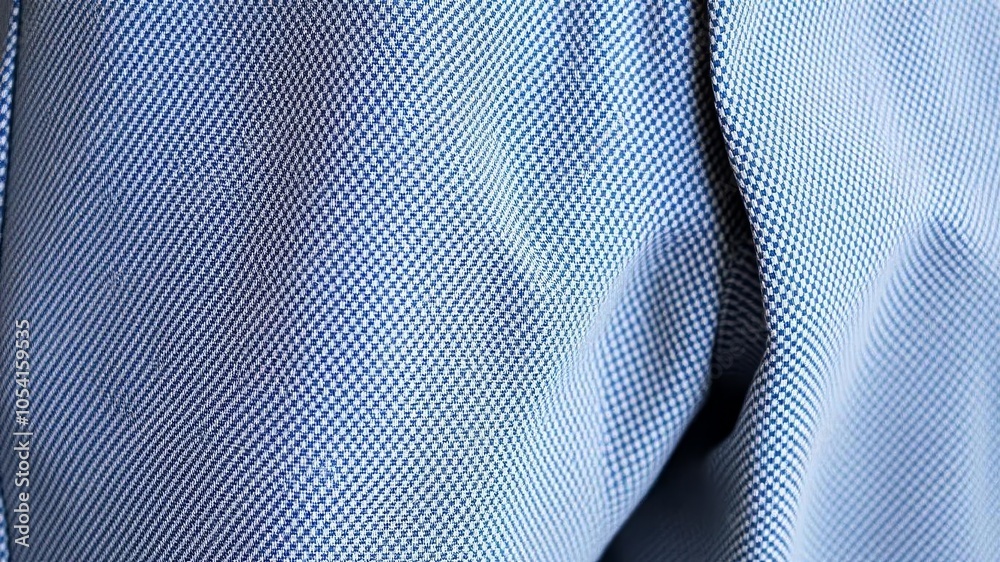 Naklejka premium Close-up shot of textured pants fabric, showing intricate weave and subtle sheen, close-up, pants