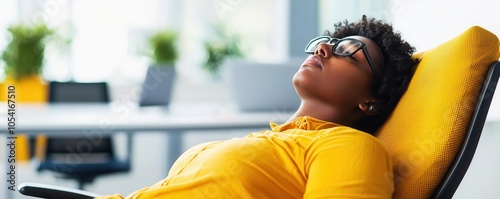 Person asleep on an office chair, underlining unplanned naps at work photo