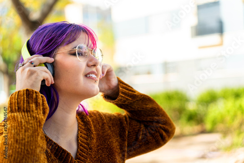 Tableau sur toile Body positive autistic girl with pink hair enjoying music