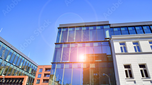 A renovation residential building and an adjacent modern office building. Modern urban development. photo