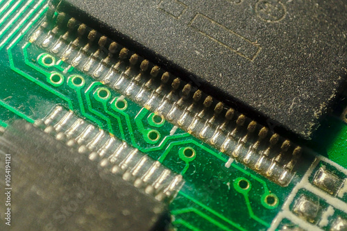 A close-up view of a printed circuit board highlights intricate details of the components and electrical pathways, showcasing technology and innovation.