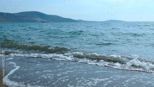 On a clear sunny day, the waves hit the shore. Sea landscape.