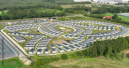 Workers housing next a greenhouse and on industrial business park. Workers migration, aerial drone view. Venlo, The Netherlands. photo