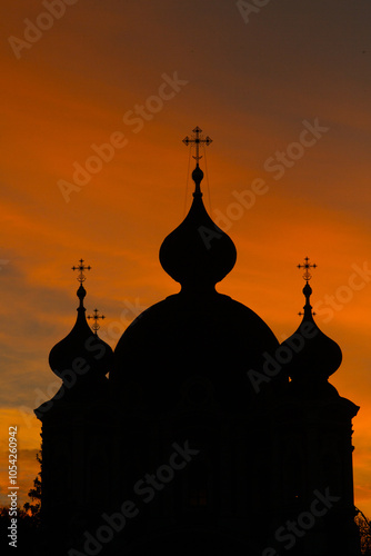 Silhouette of an Orthodox church against the background of the setting sun. photo