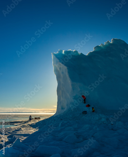 Majestic Iceberg at Pond Inlet with Adventurers Climbing