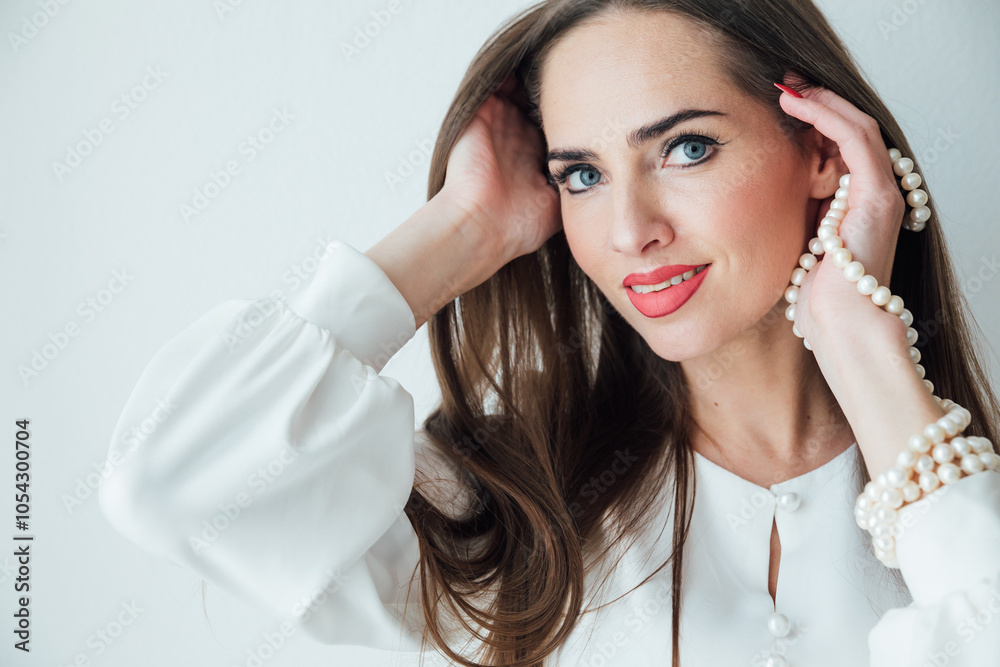 Fototapeta premium Portrait of a beautiful woman in a white summer dress smiling