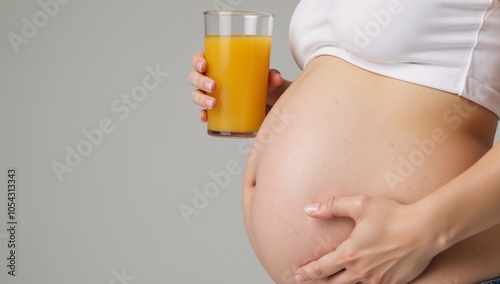 Pregnant lady clutching an orange drink