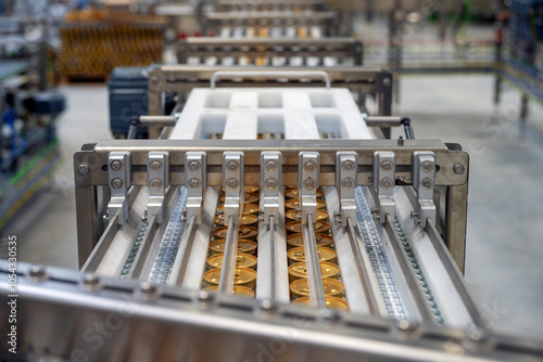 Plastic chain conveyor with cans in food manufacturing plant