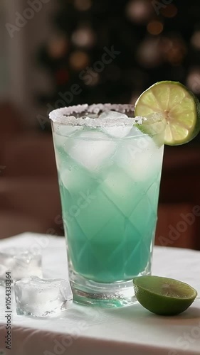 Refreshing cocktail margarita recipe with blue hue and lime garnish for summer gatherings