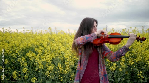 Young Lady Violin Player Practicing in Nature Pan to Rape Field