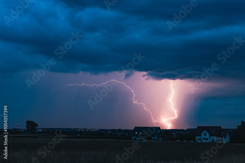 Fototapeta Naklejka Na Ścianę i Meble -  A huge storm cloud with a wall of rain in the countryside and big lightning.
