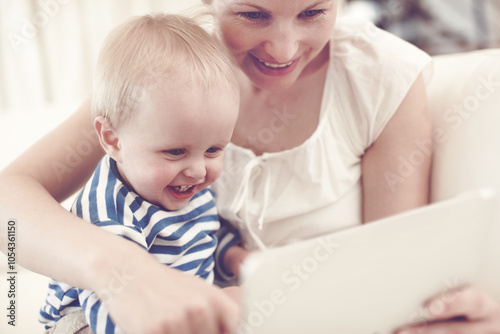 Toddler, happy or mom with boy or tablet for streaming movies, video or learning together in family home. Relax, parent and male child with mother on touchscreen technology for playing games or ebook