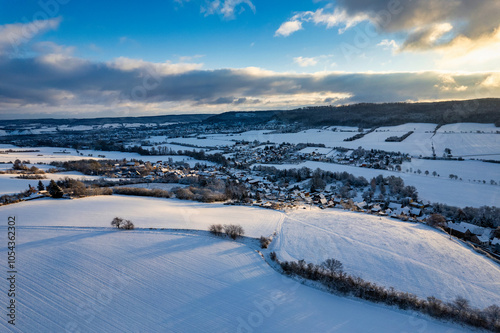 Obraz na płótnie Aerial view of a small German mountain village covered by heavy snow at sunset. Germany. w salonie