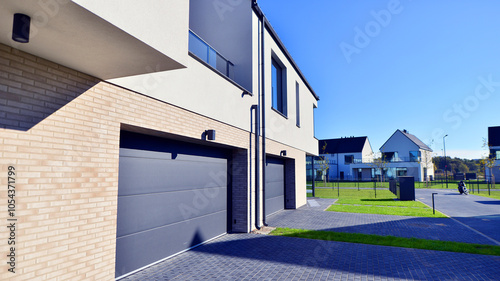 New elegant modern single family house. Terraced family homes in newly developed housing estate. Facade of a modern house with white walls. Real estate concept, european style.