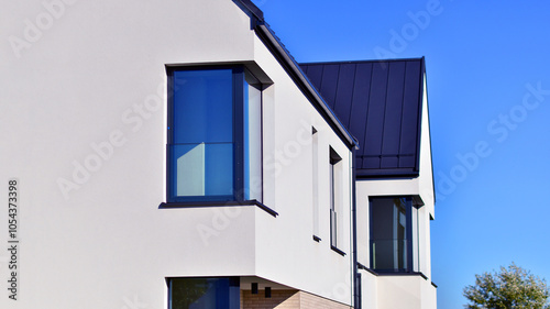 New elegant modern single family house. Terraced family homes in newly developed housing estate. Facade of a modern house with white walls. Real estate concept, european style.   photo