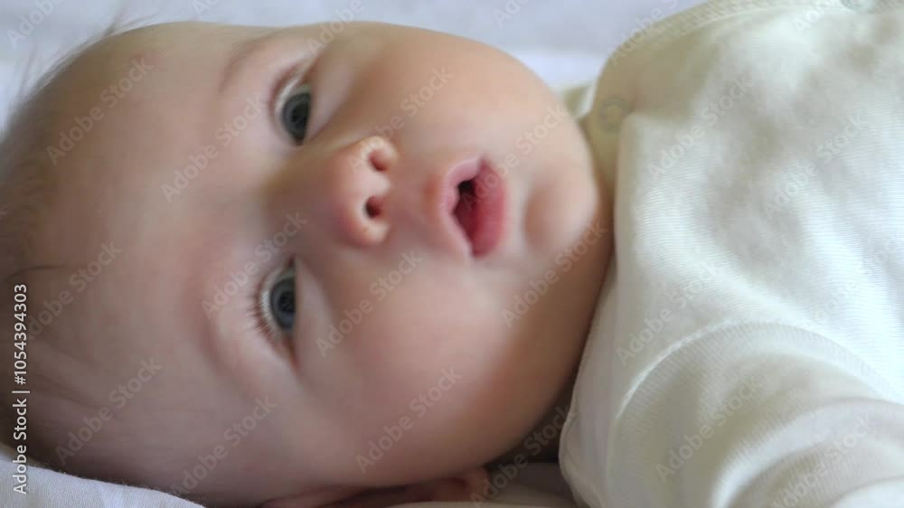 Close portrait of baby lying down on bed Close portrait of baby lying down on bed