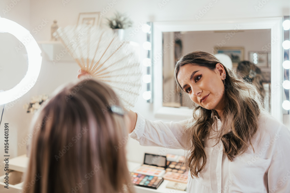 Makeup process. Professional artist applying make up on model face. Portrait of beautiful blonde woman in beauty salon. View through led beauty ring light. Makeup process. Professional artist applying make up on model face. Portrait of beautiful blonde woman in beauty salon. View through led beauty ring light.