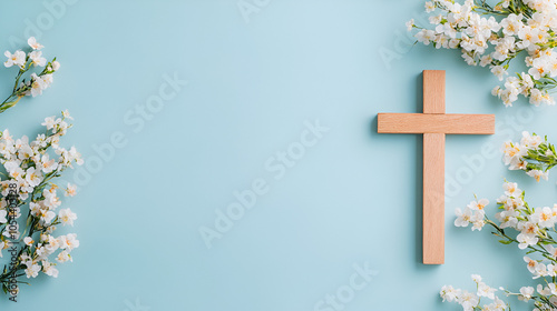 wooden cross and flowers on a light blue background, representing the Christian faith 