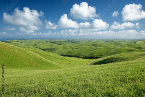 Vibrant green hills under a blue sky with fluffy clouds in a picturesque landscape during daytime