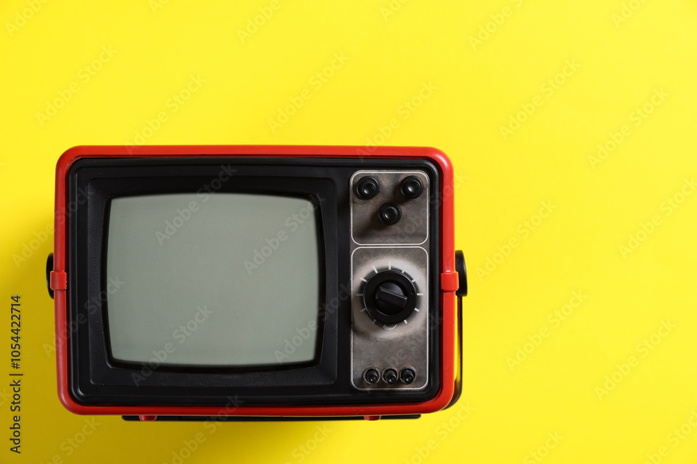 Retro tv set on yellow background, top view. Space for text Retro tv set on yellow background, top view. Space for text