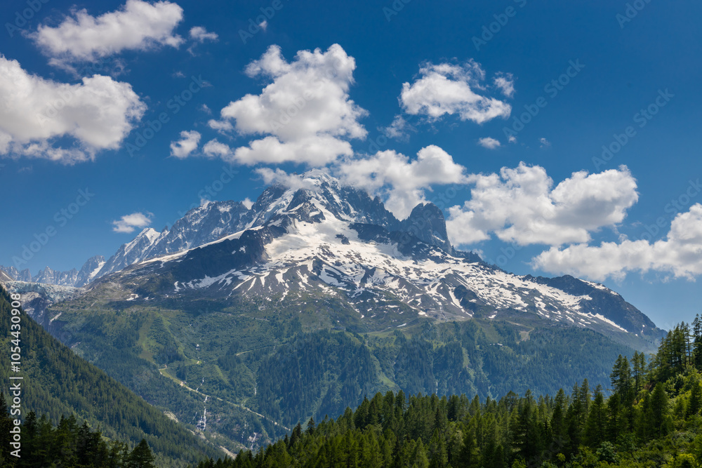Fototapeta premium The Petit Dru mountain summit displays rugged peaks and rocky formations against clear sky. Rocky peak of Aiguilles de Dru, les Drus in Chamonix Alps