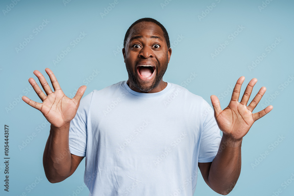 Surprised African American man looking at camera showing hands for camera Surprised African American man looking at camera showing hands for camera