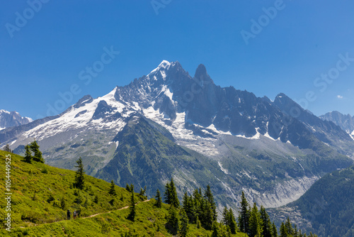 The Petit Dru mountain summit displays rugged peaks and rocky formations against clear sky. Rocky peak of Aiguilles de Dru, les Drus in Chamonix Alps