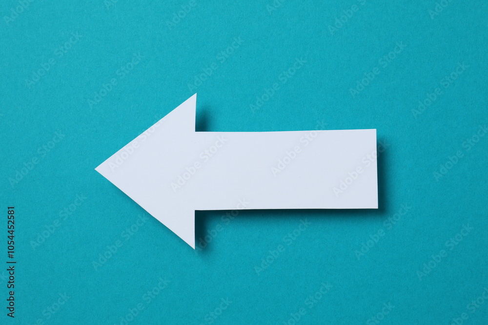 Paper arrow on color background, top view Paper arrow on color background, top view