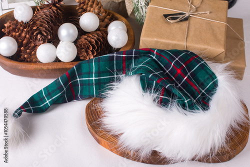 The festive New Year's hat of Santa Claus. Gifts under the Christmas tree, the concept of the new year