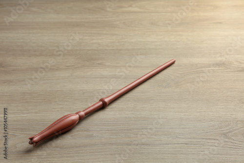 One magic wand on light wooden table