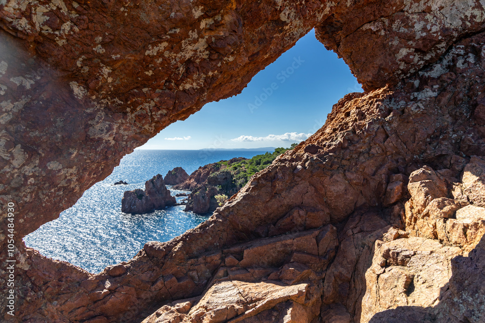 view through the red rock window on the coast of the Azure Mediterranean Sea view through the red rock window on the coast of the Azure Mediterranean Sea