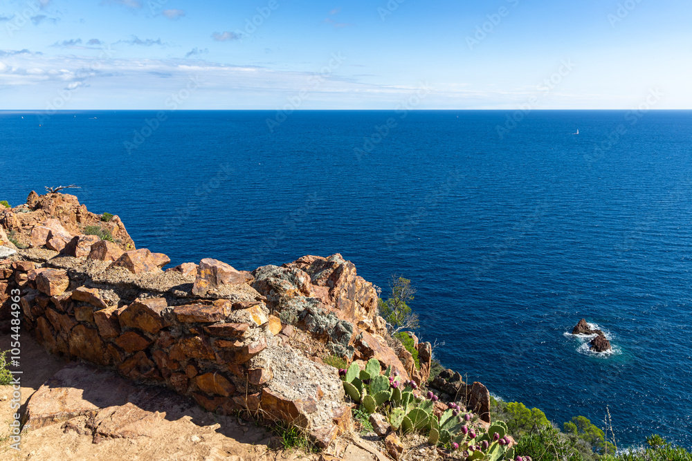 View of the Azure Mediterranean Sea with the foreground of the red rocks View of the Azure Mediterranean Sea with the foreground of the red rocks