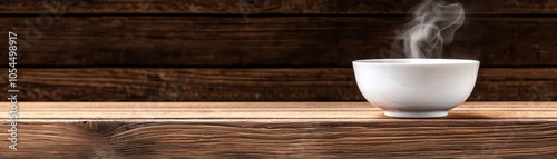 A steaming white bowl on a rustic wooden table, evoking warmth and comfort.