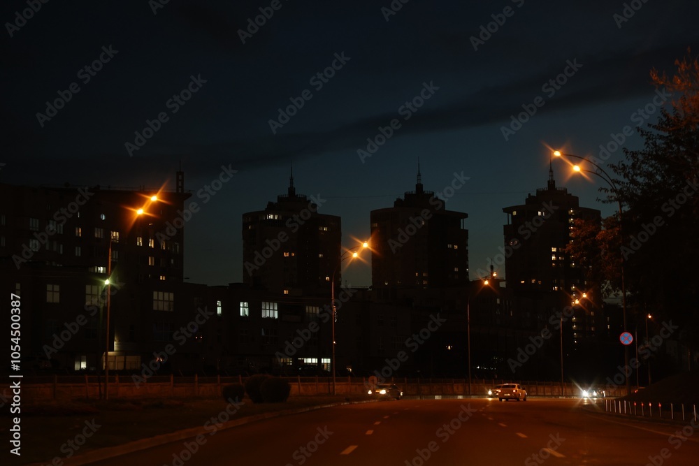 Cityscape with road traffic and street lights in evening