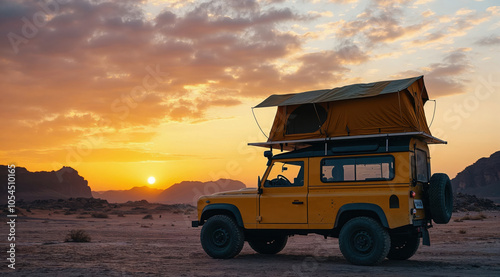 Yellow off-road vehicle parked in wadi rum desert at sunset with rooftop tent photo