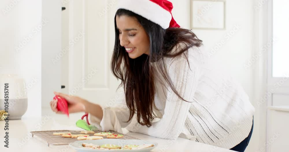 Decorating Christmas cookies, Indian woman holding icing bag at home during holiday Decorating Christmas cookies, Indian woman holding icing bag at home during holiday