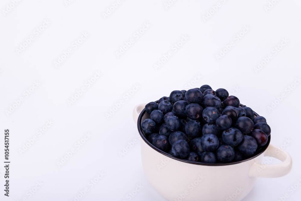 Minimalist photo of a ceramic pot full of blueberries placed on a white background, highlighting the simplicity and freshness of the fruit Minimalist photo of a ceramic pot full of blueberries placed on a white background, highlighting the simplicity and freshness of the fruit