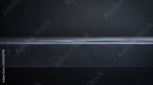Shot of a table top lit very subtly to keep dark and grey, ideal for use as a background image that can be changed in colour to meet needs of designer