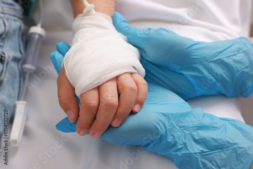 Doctor and child with IV drip in hospital, closeup